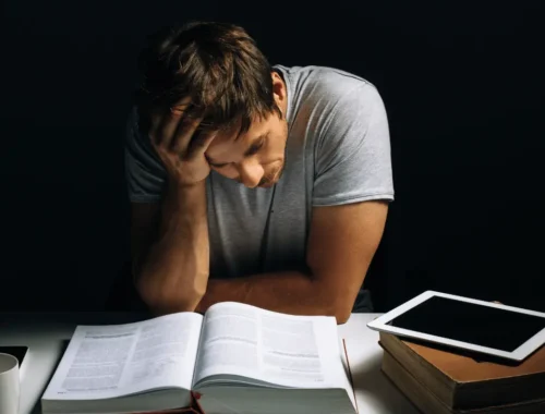 A man siting on a desk and learning how to study in a distracting environment