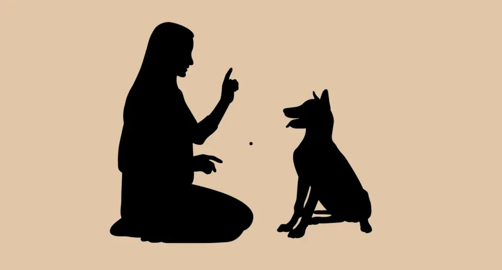 A woman sitting with a dog, pointing at it