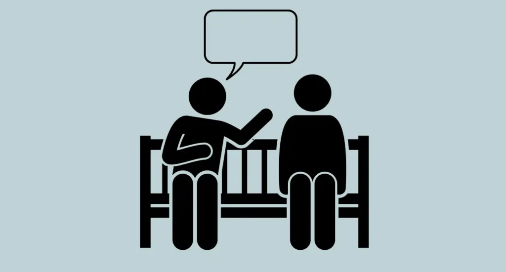 image of two individuals on a bench with a speech bubble