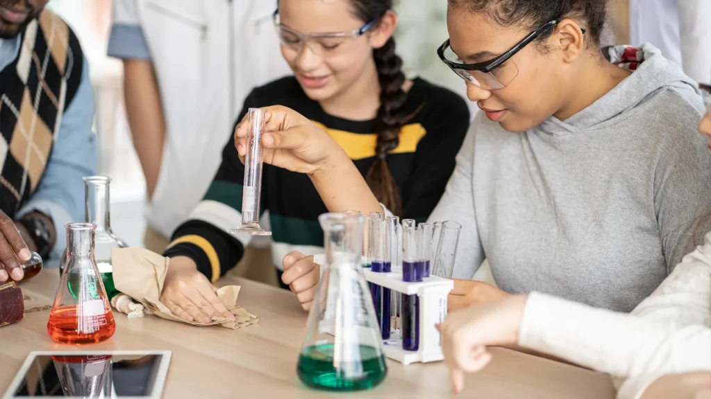 Students engaging in hands-on science experiments, demonstrating tactile learning methods as part of The Study Tips educational approach.